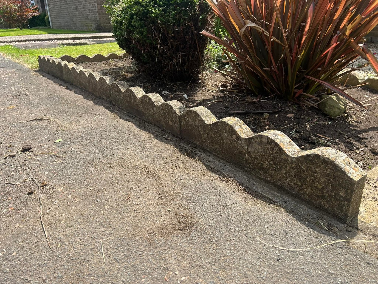 Front garden border with plants retained and edging visible